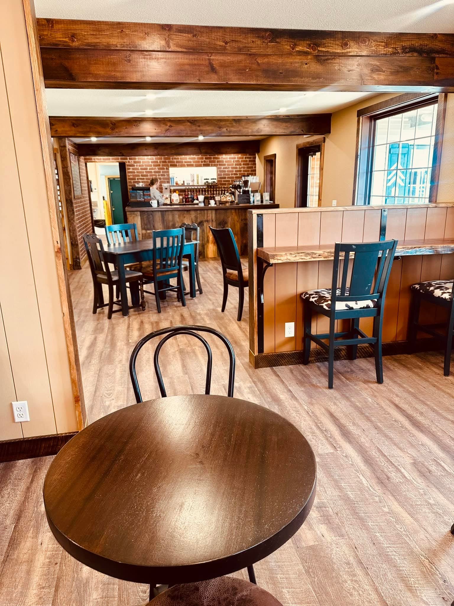 Interior of Wake Setters coffee shop — exposed brick, wooden beams, and cozy seating